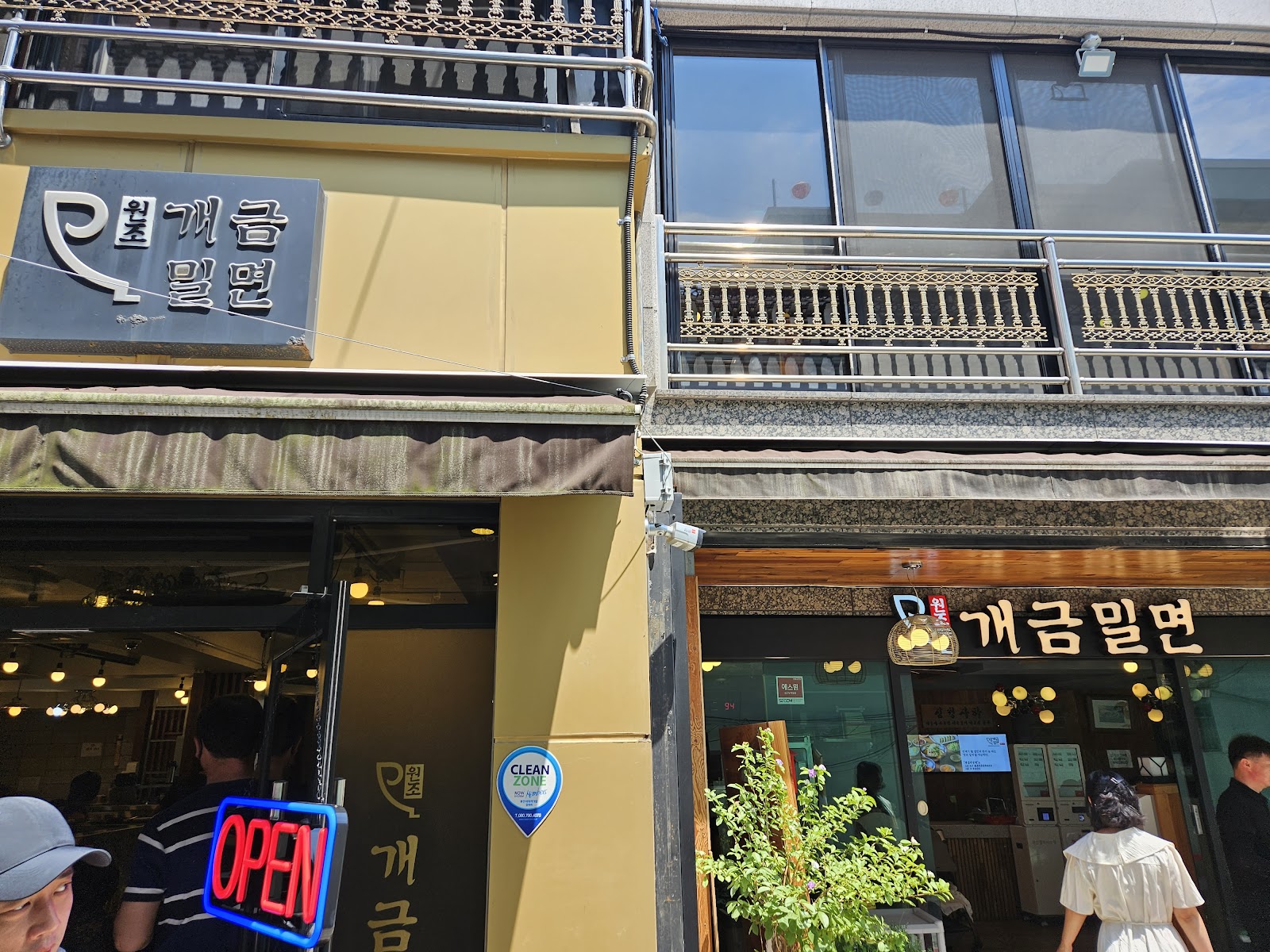 Wonjo Gaegeum Milmyeon storefront in Busan with customers queueing