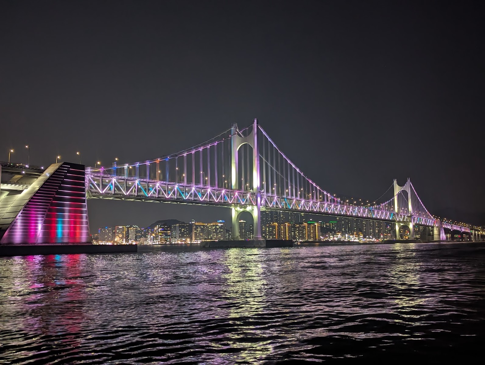 Gwangan Bridge lit up in colour at night, Busan